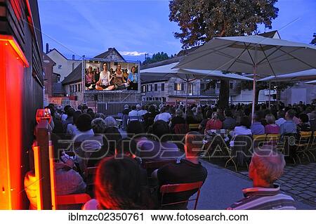 Stock Image - "Audience at the open air cinema, Lauf industrial museum, Sichartstrasse street 5-25, Lauf, Middle Franconia, Bavaria, Germany, Europe". Fotosearch