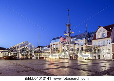 Stock Image - "Aurich market square with the market hall and the Sous Tower artwork, Aurich, East Frisia, Lower Saxony, Germany, Europe". Fotosearch