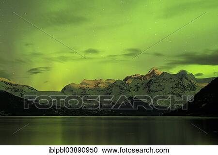 Stock Image - "Aurora borealis and moonlight on Mt Gilbert in the Chugach Range, Barry Arm, Prince William Sound, Alaska, USA". Fotosearch