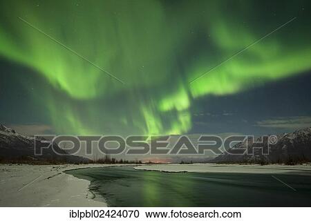 Stock Image - Aurora Borealis over the Knik River Valley, Alaska. Fotosearch