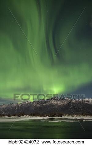 Stock Image - Aurora Borealis over the Knik River Valley, Alaska. Fotosearch