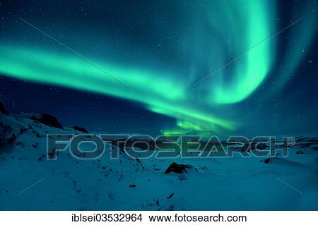 Picture - "Aurora over a fjord with snow-covered mountains, Tromso, â€ªTroms, Northern Norway, Norway, Europe". Fotosearch