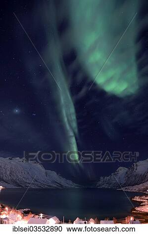 "Aurora over a fjord with snow-covered mountains and an illuminated village, Ersfjord, Tromso, ‪Troms, Northern Norway, Norway, Europe" View Large Photo Image Stock Image - "Aurora over a fjord with snow-covered mountains and an illuminated village, Ersfjord, Tromso, ‪Troms, Northern Norway, Norway, Europe". Fotosearch