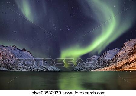 "Aurora over a fjord with snow-covered mountains, Ersfjord, Tromso, ‪Troms, Northern Norway, Norway, Europe" View Large Photo Image Stock Photo - "Aurora over a fjord with snow-covered mountains, Ersfjord, Tromso, ‪Troms, Northern Norway, Norway, Europe". Fotosearch