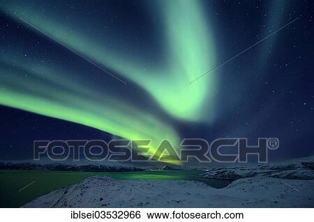 Stock Photograph - "Aurora over a fjord with snow-covered mountains, Tromso, â€ªTroms, Northern Norway, Norway, Europe". Fotosearch