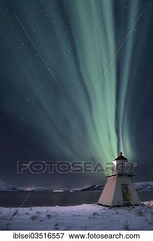Stock Photo - "Aurora over fjord with lighthouse in winter, Tromso, â€ªTroms, Northern Norway, Norway, Europe". Fotosearch