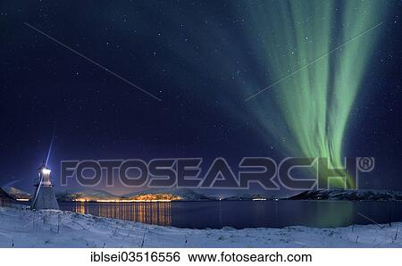 Stock Photograph - "Aurora over fjord with lighthouse in winter, Tromso, â€ªTroms, Northern Norway, Norway, Europe". Fotosearch