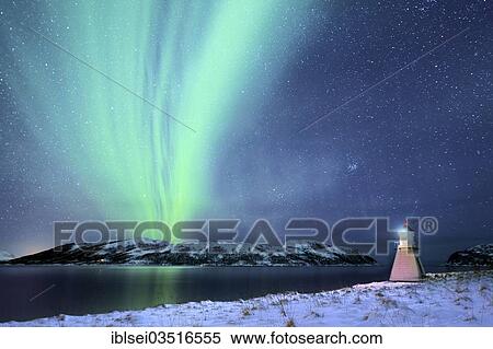 Stock Photography - "Aurora over fjord with lighthouse in winter, Tromso, â€ªTroms, Northern Norway, Norway, Europe". Fotosearch
