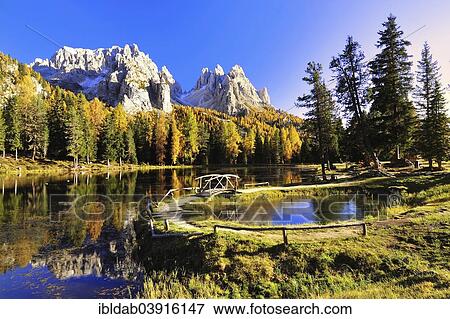 "Autumn at Lake d'Antorno with a wooden bridge and the reflection of the Cadini Misurina Mountains, Dolomites, Belluno province, Veneto region, Alto Adige, Italy, Europe" View Large Photo Image Stock Photo - "Autumn at Lake d'Antorno with a wooden bridge and the reflection of the Cadini Misurina Mountains, Dolomites, Belluno province, Veneto region, Alto Adige, Italy, Europe". Fotosearch