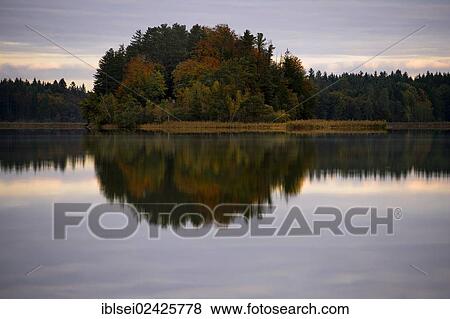 "Autumnal island with reflection Lake Ostersee, Iffeldorf, Upper Bavaria, Bavaria, Germany, Europe" View Large Photo Image Stock Photo - "Autumnal island with reflection Lake Ostersee, Iffeldorf, Upper Bavaria, Bavaria, Germany, Europe". Fotosearch