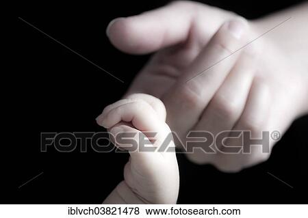 Baby gripping his mother's finger with his hand View Large Photo Image Stock Photo - Baby gripping his mother's finger with his hand. Fotosearch
