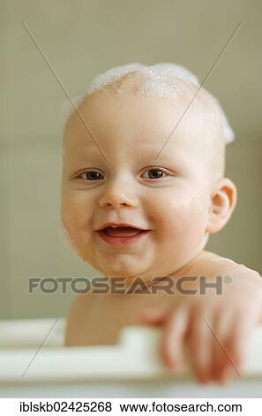 Baby in a bath with foam on his head View Large Photo Image Stock Photo - Baby in a bath with foam on his head. Fotosearch