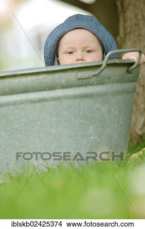 "Baby, one year, bathing in a zinc tub outdoors" View Large Photo Image Picture - "Baby, one year, bathing in a zinc tub outdoors". Fotosearch