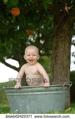 "Baby, one year, bathing in a zinc tub outdoors" View Large Photo Image Stock Image - "Baby, one year, bathing in a zinc tub outdoors". Fotosearch