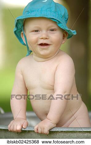 Stock Photo - "Baby, one year, bathing in a zinc tub outdoors". Fotosearch
