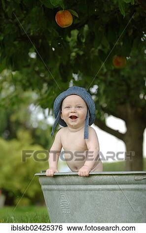 "Baby, one year, bathing in a zinc tub outdoors" View Large Photo Image Stock Photograph - "Baby, one year, bathing in a zinc tub outdoors". Fotosearch