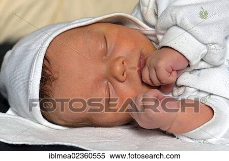 Baby sleeping with closed fists View Large Photo Image Stock Photography - Baby sleeping with closed fists. Fotosearch