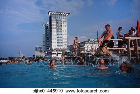 "Badeschiff bathing ship, public swimming pool on the Spree river, Treptowers high-rise buildings and Molecule Man in the back, in Kreuzberg district, Berlin, Germany, Europe" View Large Photo Image Stock Photo - "Badeschiff bathing ship, public swimming pool on the Spree river, Treptowers high-rise buildings and Molecule Man in the back, in Kreuzberg district, Berlin, Germany, Europe". Fotosearch