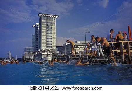 "Badeschiff bathing ship, public swimming pool on the Spree river, Treptowers high-rise buildings and Molecule Man in the back, in Kreuzberg district, Berlin, Germany, Europe" View Large Photo Image Stock Photography - "Badeschiff bathing ship, public swimming pool on the Spree river, Treptowers high-rise buildings and Molecule Man in the back, in Kreuzberg district, Berlin, Germany, Europe". Fotosearch