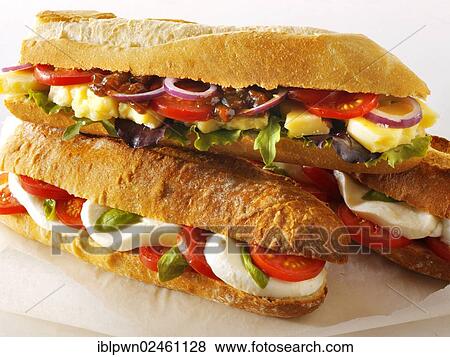 "Baguettes filled with mozzarella and tomatoes, and cheddar ploughman's with chutney" View Large Photo Image Stock Photo - "Baguettes filled with mozzarella and tomatoes, and cheddar ploughman's with chutney". Fotosearch