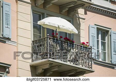 Stock Image - "Balcony with a sun umbrella, Pontresina, Canton of Graubunden, Switzerland, Europe". Fotosearch
