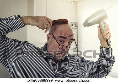 Stock Photo - "Bald man with a comb and a hair dryer hairdressing, Germany, Europe". Fotosearch