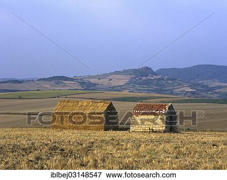 "Bales of straw stacked in the shape of a house next to a little stone house, Limagne, Auvergne, France, Europe" View Large Photo Image Stock Photo - "Bales of straw stacked in the shape of a house next to a little stone house, Limagne, Auvergne, France, Europe". Fotosearch