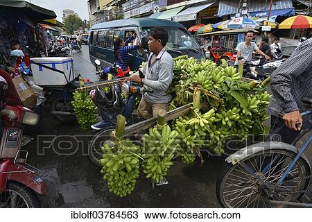 Stock Image - "Banana seller with a moped, market, Phnom Penh, Cambodia, Asia". Fotosearch