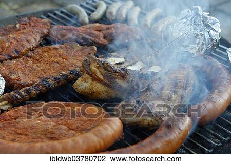 "Barbecue meat, spare ribs and sausages on a grill, barbecue" View Large Photo Image Stock Image - "Barbecue meat, spare ribs and sausages on a grill, barbecue". Fotosearch