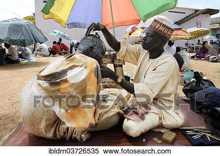 Stock Photography - "Barber at the market of Ngaoundere, Ngaoundere, Adamawa Region, Cameroon, Africa". Fotosearch