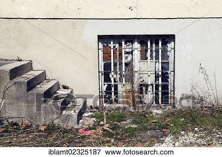 "Barred windows and stairs of a dilapidated building with bushes and weeds, Munich, Bavaria, Germany, Europe, PublicGround, Europe" View Large Photo Image Stock Photo - "Barred windows and stairs of a dilapidated building with bushes and weeds, Munich, Bavaria, Germany, Europe, PublicGround, Europe". Fotosearch