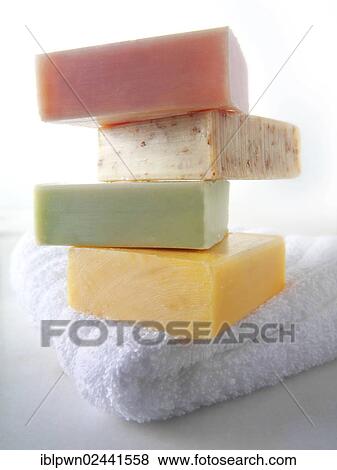 Bars of soap piled on a white towel View Large Photo Image Stock Photo - Bars of soap piled on a white towel. Fotosearch