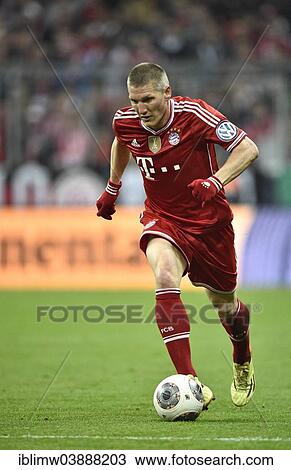 Stock Image - "Bastian Schweinsteiger, Bayern Munich, playing the ball, Allianz Arena, football stadium, Munich, Upper Bavaria, Bavaria, Germany, Europe". Fotosearch