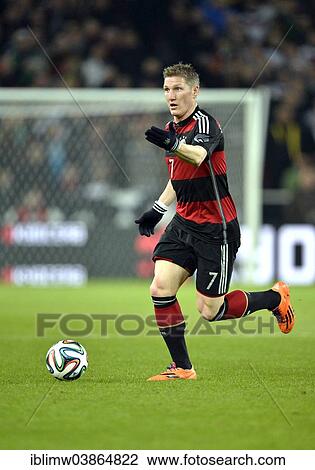 Stock Image - "Bastian Schweinsteiger wearing the away strip, on the ball, international match between Germany - Chile, Mercedes-Benz Arena, Stuttgart, Baden-Wurttemberg, Germany, Europe". Fotosearch