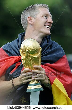 "Bastian Schweinsteiger with the trophy, reception of the German national team after their victory at the FIFA World Cup 2014, fan party at the Brandenburg Gate, Berlin, Germany, Europe" View Large Photo Image Stock Photograph - "Bastian Schweinsteiger with the trophy, reception of the German national team after their victory at the FIFA World Cup 2014, fan party at the Brandenburg Gate, Berlin, Germany, Europe". Fotosearch