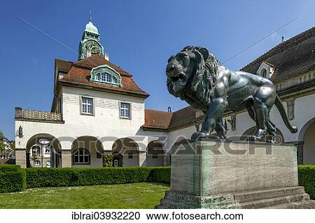 "Bath houses and bronze sculpture """"Walking Lion"""" by Heinrich Jobst, Sprudelhof courtyard, spa resort in Art Nouveau style, Bad Nauheim, Hesse, Germany, Europe" View Large Photo Image Stock Image - "Bath houses and bronze sculpture """"Walking Lion"""" by Heinrich Jobst, Sprudelhof courtyard, spa resort in Art Nouveau style, Bad Nauheim, Hesse, Germany, Europe". Fotosearch