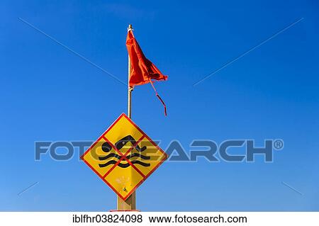 "Bathing prohibition sign with red flag in front of a blue sky, beach, Spain, Europe" View Large Photo Image Stock Photo - "Bathing prohibition sign with red flag in front of a blue sky, beach, Spain, Europe". Fotosearch
