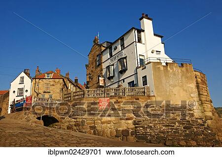 Stock Image - "Bay Hotel Pub, village and slipway of historic fishing village of Robin Hood's Bay, North Yorkshire, England, United Kingdom, Europe". Fotosearch