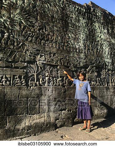 "Bayon temple, girl pointing at a relief, wall relief, eastern facade, Angkor Thom, Siem Reap Province, Cambodia, Asia" View Large Photo Image Stock Image - "Bayon temple, girl pointing at a relief, wall relief, eastern facade, Angkor Thom, Siem Reap Province, Cambodia, Asia". Fotosearch