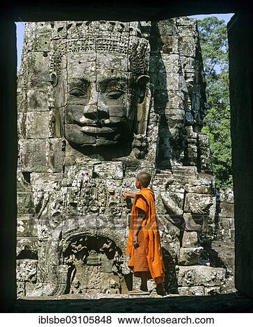 Stock Photo - "Bayon temple, monk, face tower, face of Bodhisattva Lokeshvara, Avalokiteshvara, Angkor Thom, Siem Reap Province, Cambodia, Asia". Fotosearch