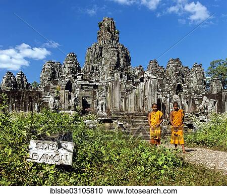 Stock Image - "Bayon temple, monks, novices at the south entrance, faces-towers, Angkor Thom, Siem Reap Province, Cambodia, Asia". Fotosearch