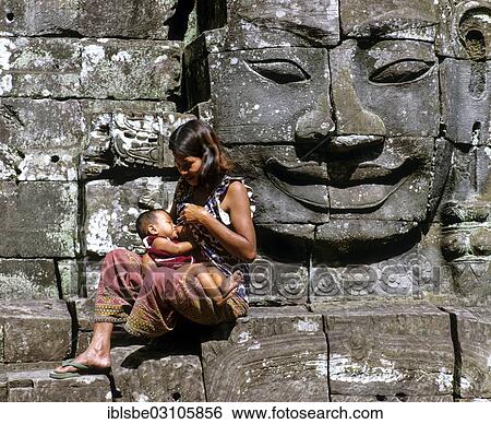 Stock Photograph - "Bayon temple, mother nursing child, face tower, face of Bodhisattva Lokeshvara, Avalokiteshvara, Angkor Thom, Siem Reap Province, Cambodia, Asia". Fotosearch