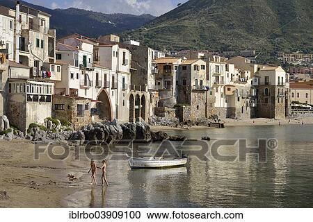 Stock Image - "Beach and houses of the historic centre, Cefalu, Province of Palermo, Sicily, Italy, Europe". Fotosearch
