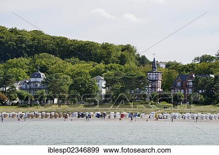 "Beach and roofed wicker beach chairs in front of resort or Baeder architecture, Binz, Mecklenburg-Western Pomerania, Germany, Europe" View Large Photo Image Stock Photo - "Beach and roofed wicker beach chairs in front of resort or Baeder architecture, Binz, Mecklenburg-Western Pomerania, Germany, Europe". Fotosearch