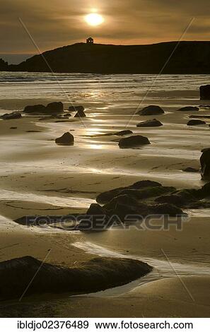 Stock Photo - "Beach at the Cote Sauvage at sunset, a lone house in the distance, on the west side of the Quiberon peninsula, southern Brittany, Bretagne, France, Europe". Fotosearch
