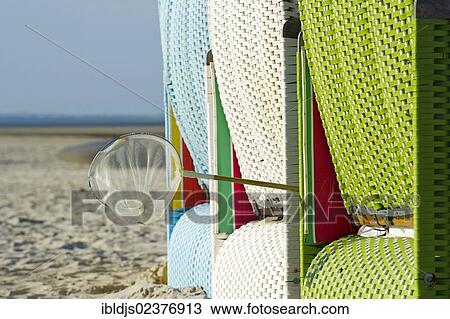 Stock Image - "Beach chairs and a fishing net, Utersum, Foehr island, North Frisia, Schleswig-Holstein, Germany, Europe". Fotosearch