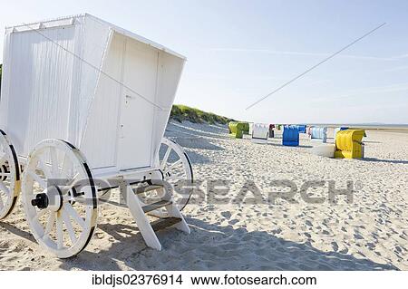 Picture - "Beach chairs and a historical changing hut or cart, Utersum, Foehr island, North Frisia, Germany, Europe". Fotosearch