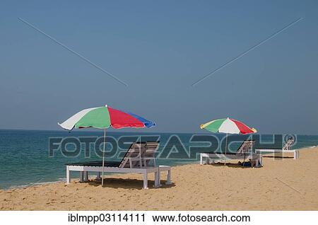 Stock Image - "Beach chairs and parasols by the Indian Ocean, Kerala, India, Asia". Fotosearch