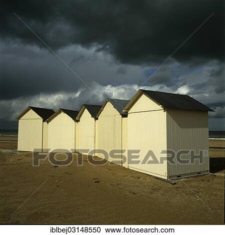 Stock Image - "Beach huts under a stormy sky, Normandy, France, Europe". Fotosearch