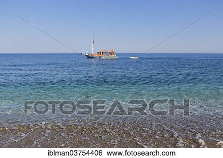 Stock Photograph - "Beach of Olympos, excursion boat in the sea, Lycian Coast, Kemer, Lycia, Province of Antalya, Turkey, Asia". Fotosearch